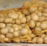 a pile of potatoes sitting on top of a wooden pallet