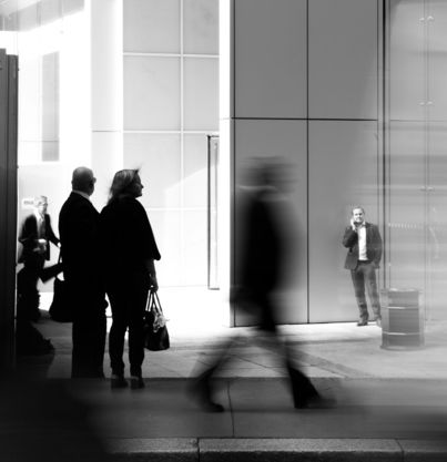 grayscale photo of people walking towards building