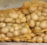 a pile of potatoes sitting on top of a wooden pallet